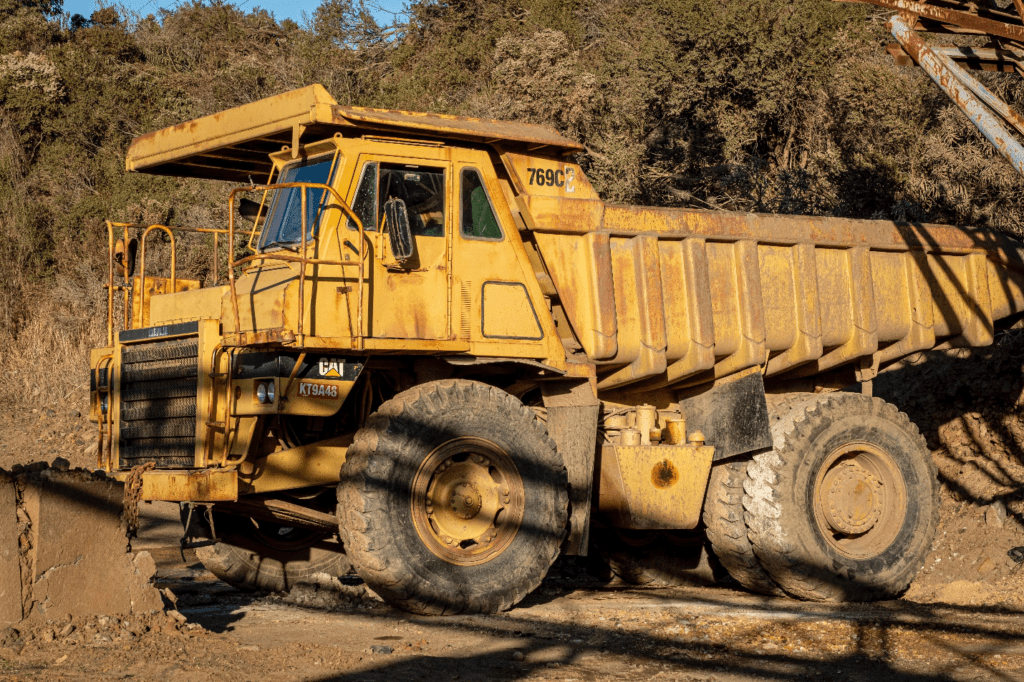 A yellow dump truck at a building site