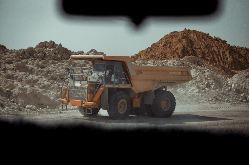 A dump truck is parked in a mining area
