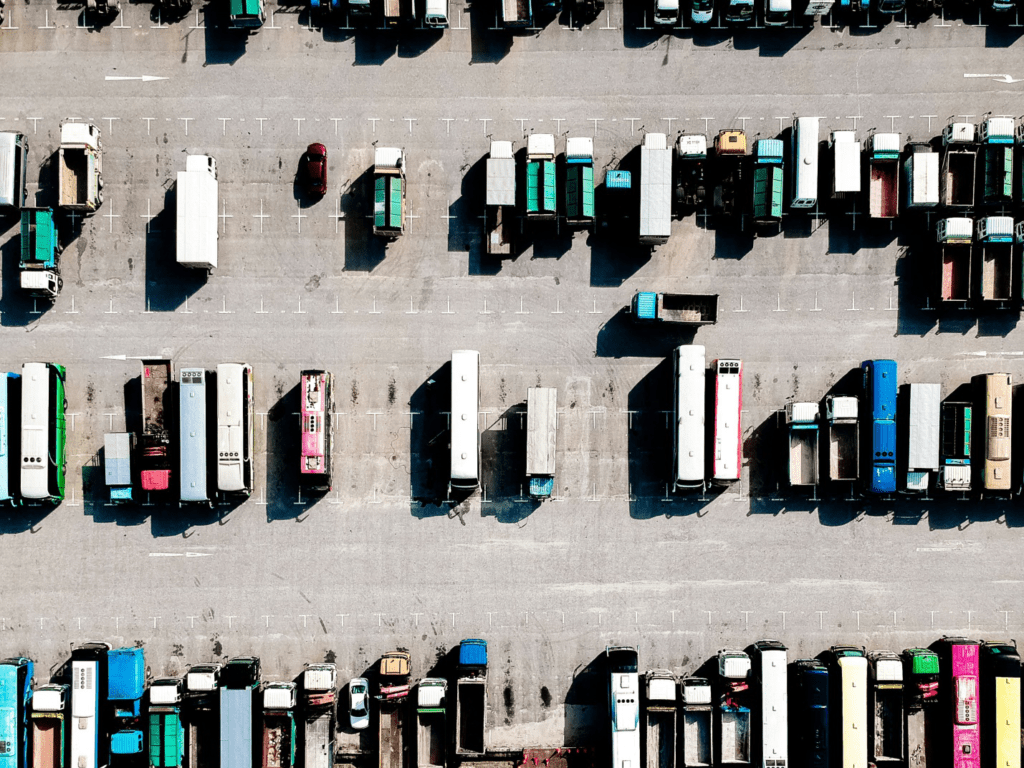 many dump trucks in a parking lot