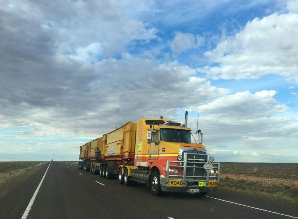 A modern vehicle on a highway that uses dump truck telematics for operational efficiency