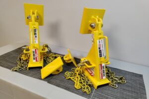 Two yellow BedLock safety stands placed on a workshop table.