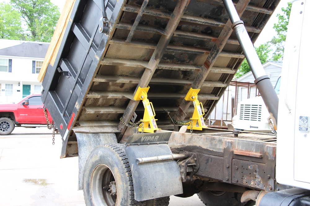 BedLock securely supports a raised dump truck bed, ensuring maximum stability and safety