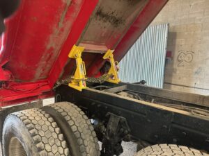 Two BedLock safety support devices installed on a raised dump truck bed