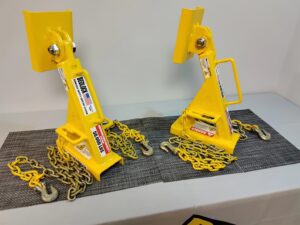 Two BedLock dump truck bed locks displayed on a table for inspection