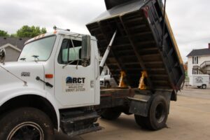 A dump truck bed raised on safety props.