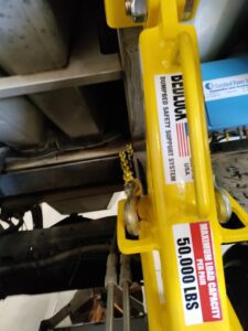 Close-up of a bed lock showing a 50000 lbs capacity label