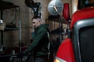Technician working on a truck in a repair shop