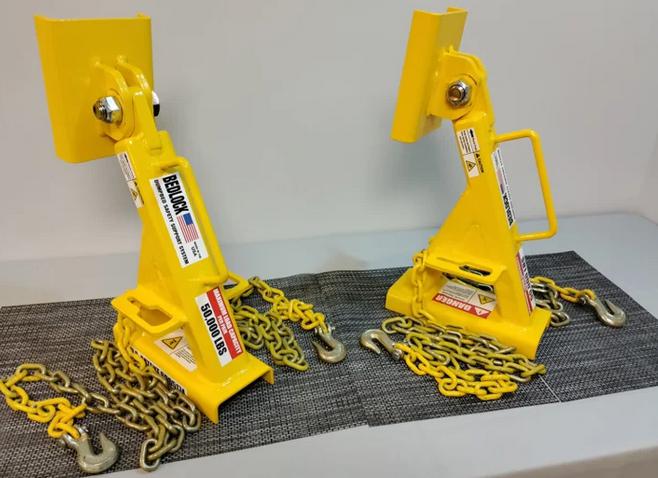 Two truck bed locks placed on a surface for heavy-duty maintenance use