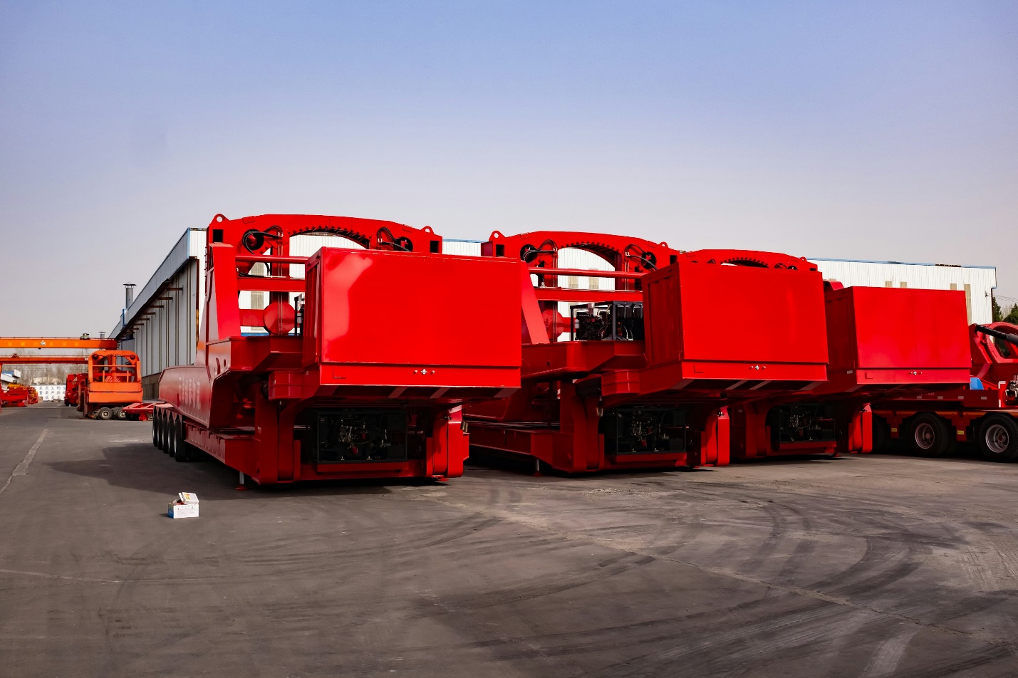 Red trailers fleet parked near a warehouse