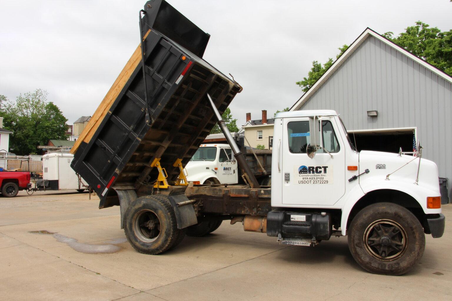 A dump truck bed raised on safety props.