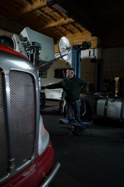 Technician inspecting a truck in a repair shop