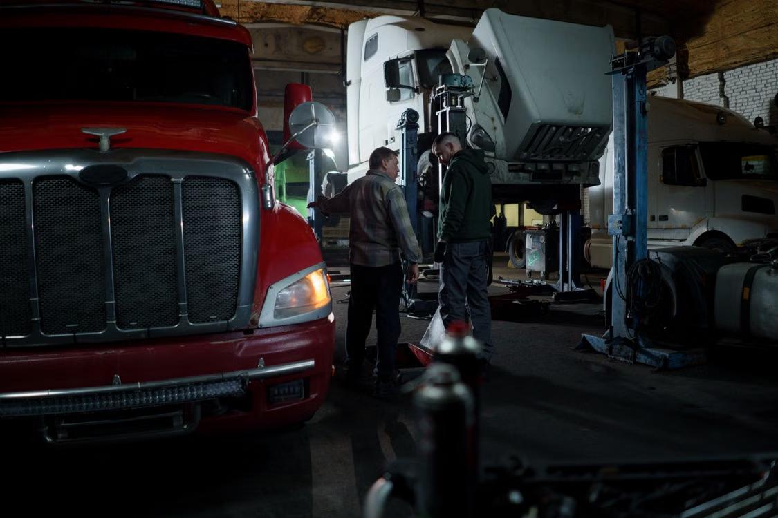 Technician repairing a truck in a workshop