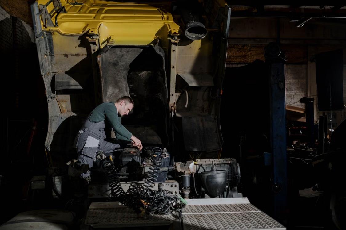 Technician repairing a truck in a workshop