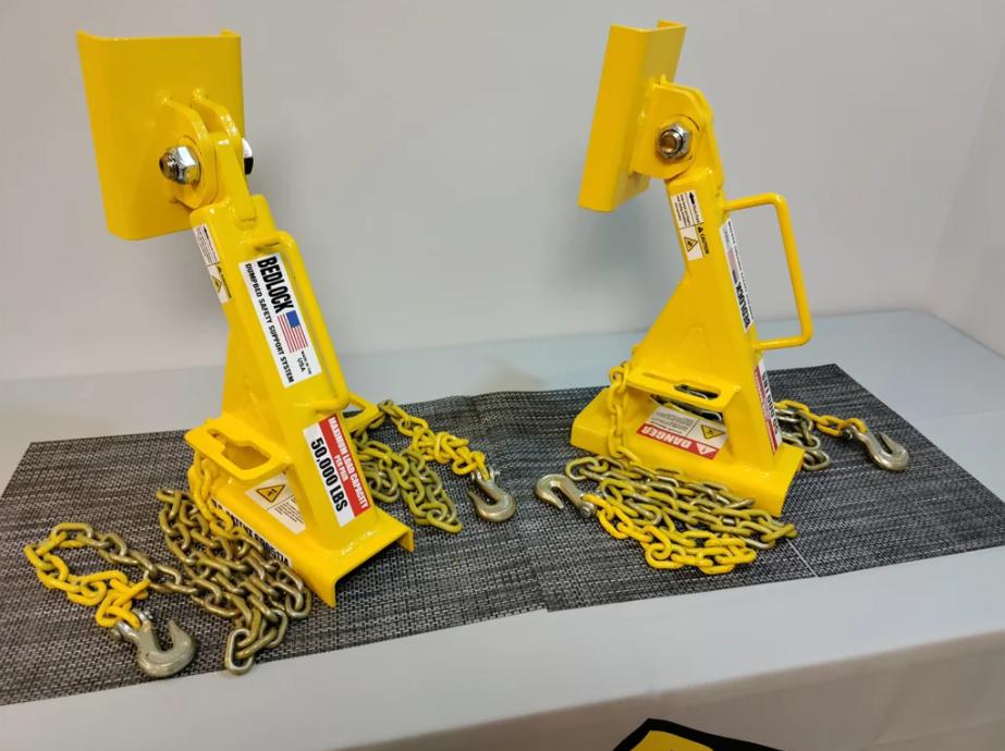 BL-700A/B BedLock Systems with chains designed to support raised dump truck beds during maintenance.